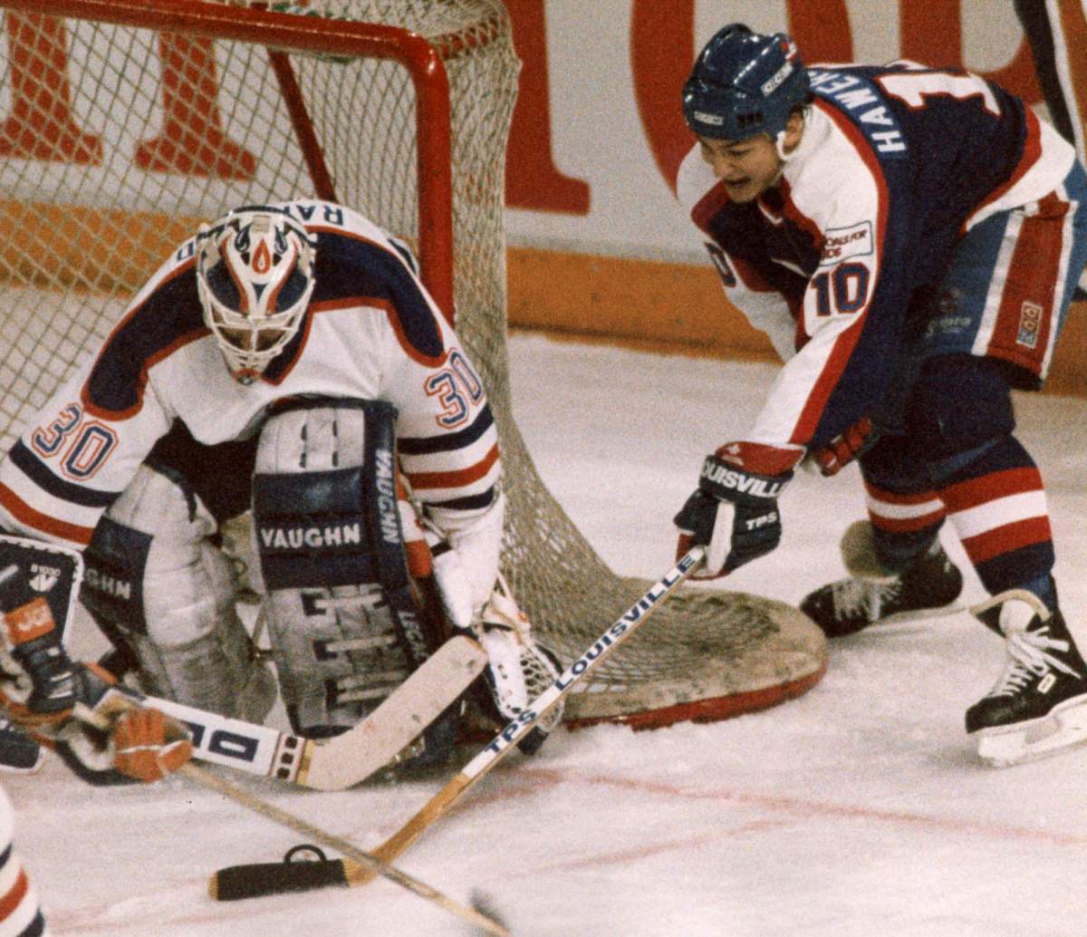 Winnipeg Jets’ Dale Hawerchuk tries a wraparound move on Edmonton Oilers’ Bill Ranford during NHL action in Edmonton on April 4, 1990. Longtime Winnipeg Jets star Dale Hawerchuk has died after a battle with cancer. He was 57.