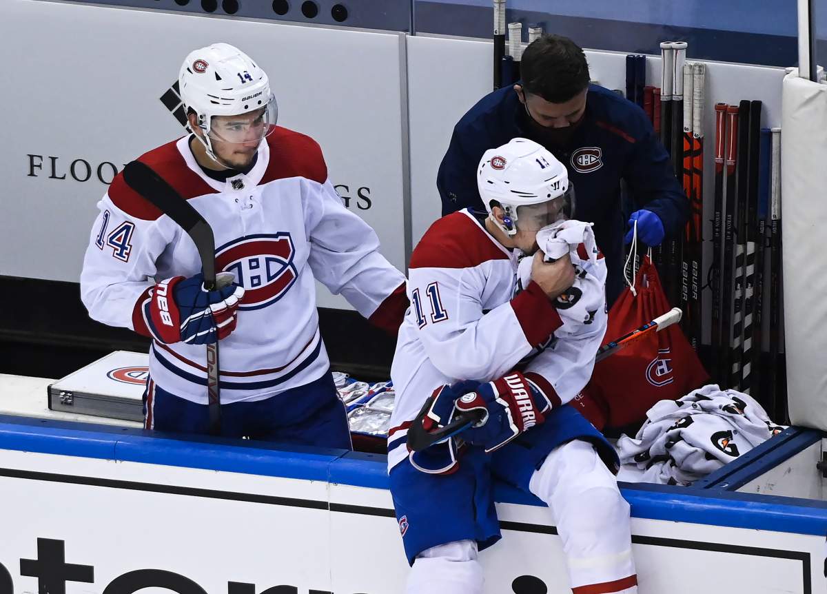 Montreal Canadiens right wing Brendan Gallagher (11) holds a towel on his mouth as Canadiens centre Nick Suzuki (14) checks on him after defeating the Philadelphia Flyers during NHL Eastern Conference Stanley Cup playoff hockey action in Toronto on Wednesday, August 19, 2020. Flyers' Matt Niskanen has received a one-game suspension for his cross-check on Brendan Gallagher late in Wednesday’s game. 