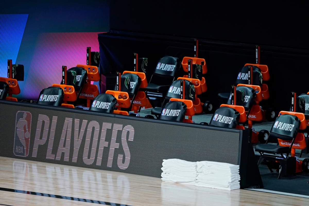 The Milwaukee Bucks bench remains empty at the scheduled start of an NBA basketball first round playoff game against the Orlando Magic, Aug. 26, 2020, in Lake Buena Vista, Fla.