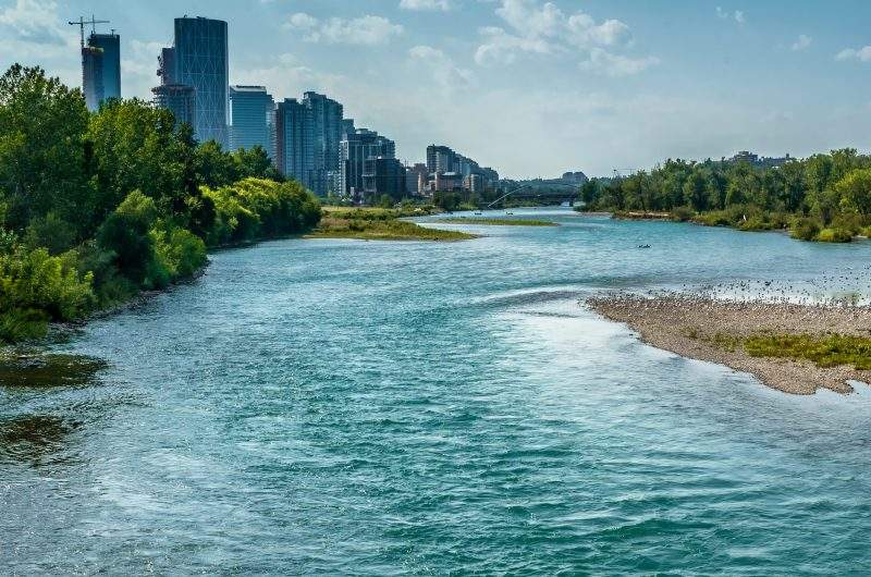The quickly flowing Bow River runs through downtown Calgary in summer 2021.
