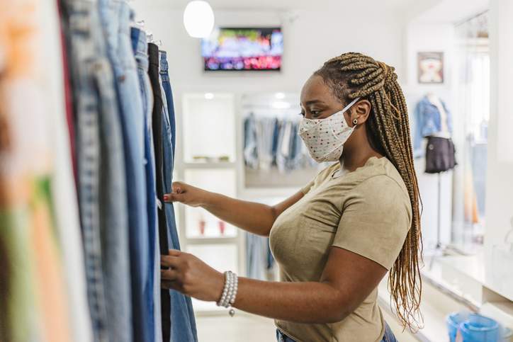 A woman wears a face mask while shopping. 