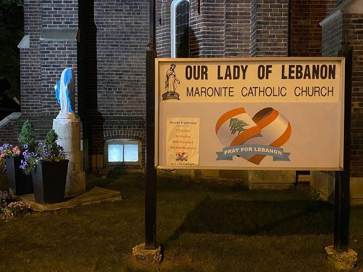 The vandalized statue of the Virgin Mary can be seen outside the church in Toronto.