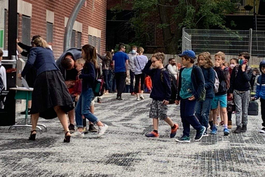 Students line up outside a Montreal school on Aug. 27, 2020. Quebec has updated its back-to-school plan for 2021 amid the COVID-19 pandemic, sparking concerns over air quality in classrooms. 