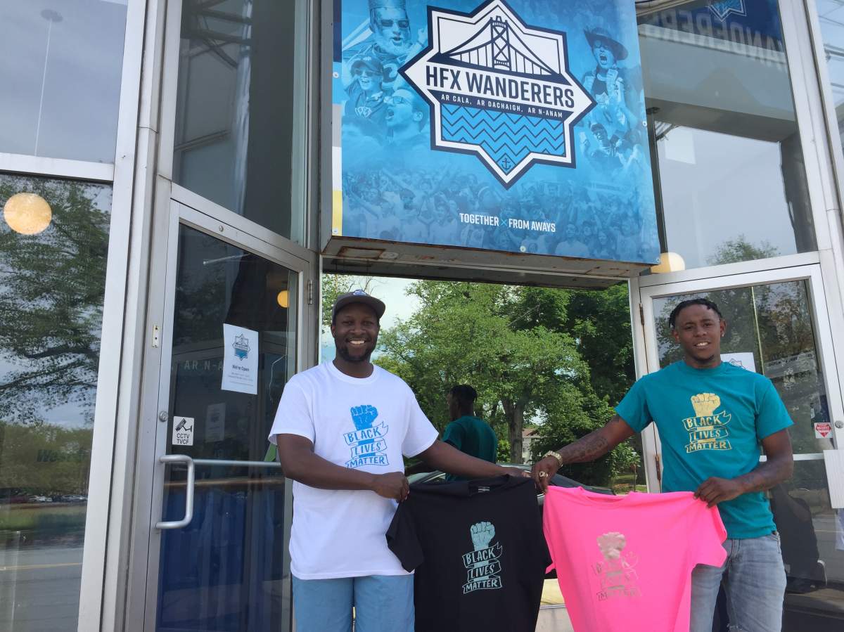 Marvin Okello (left) stands with co-owner of Creations by Kyy, Birt Beals, who produced the Black Lives Matter shirts for the Halifax Wanderers.