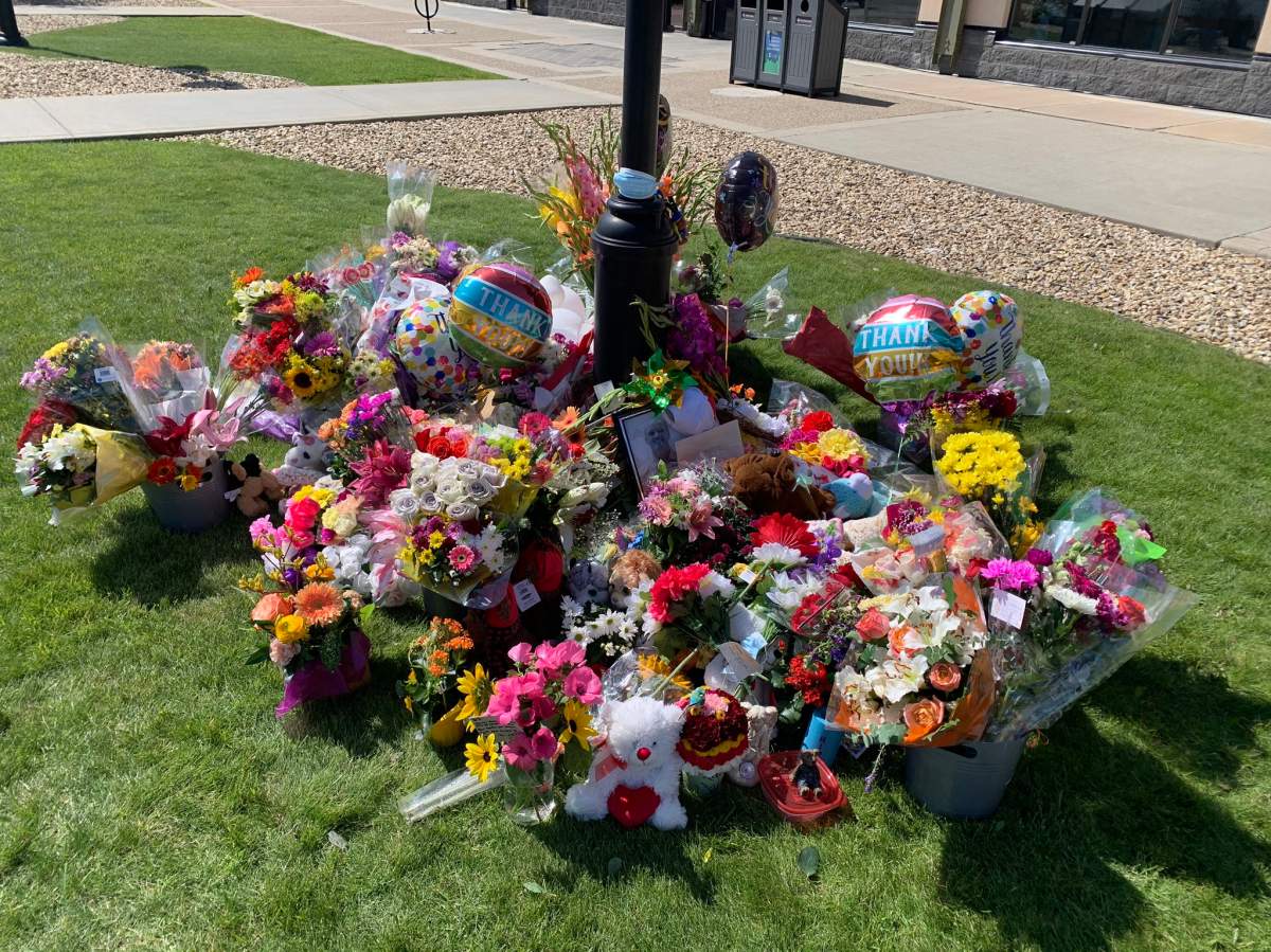 A memorial for slain Red Deer doctor Dr. Walter Reynolds outside the Village Mall Walk-in Clinic in Red Deer, Alta. on Wednesday, August 12, 2020.