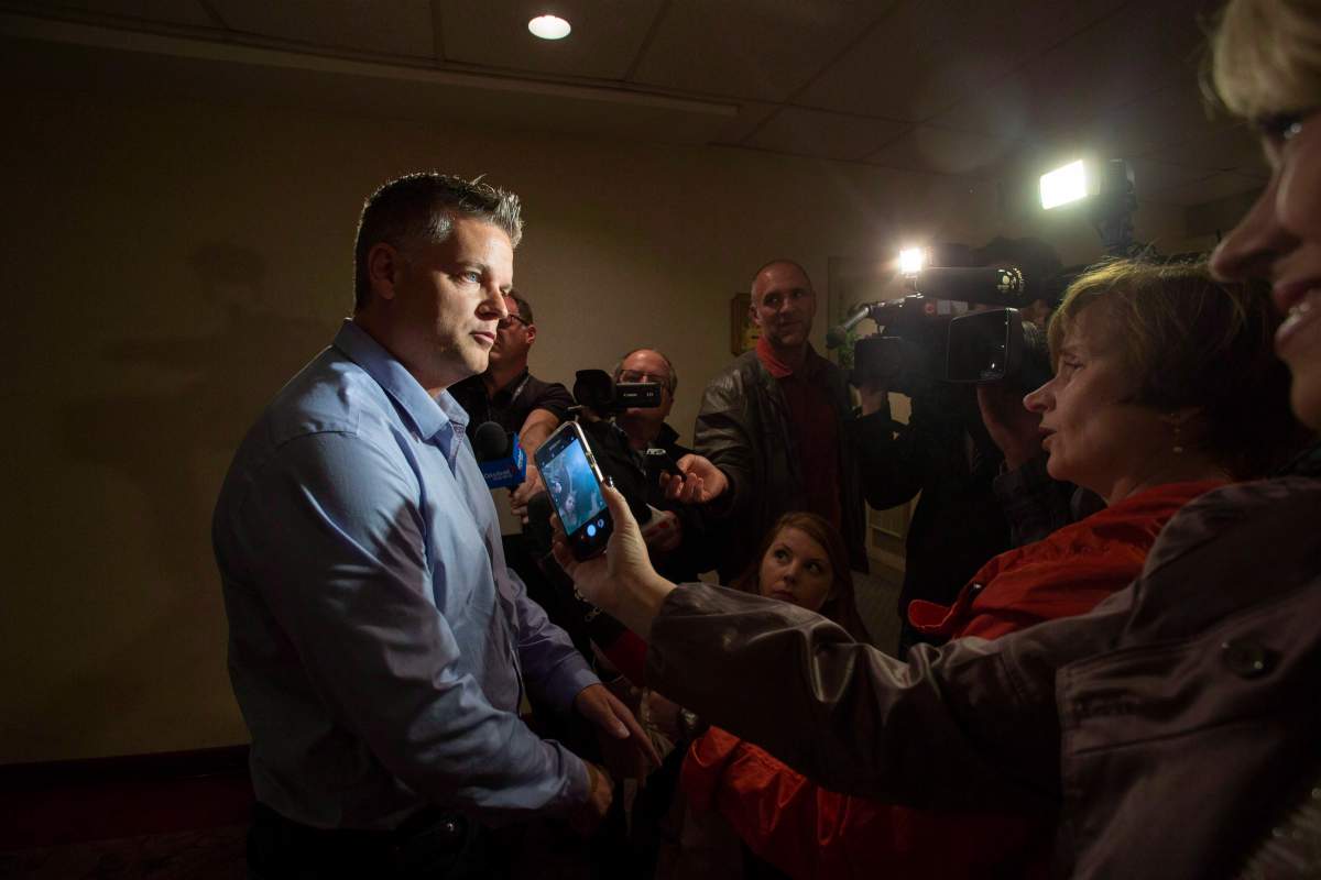 New Brunswick Progressive Conservative candidate Robert Gauvin answers questions from the media in Fredericton on Thursday, Sept. 27, 2018. A former Tory deputy premier is now the Liberal candidate for the riding of Shediac Bay-Dieppe in New Brunswick's provincial election. Liberal Leader Kevin Vickers announced the nomination of Robert Gauvin this morning. 