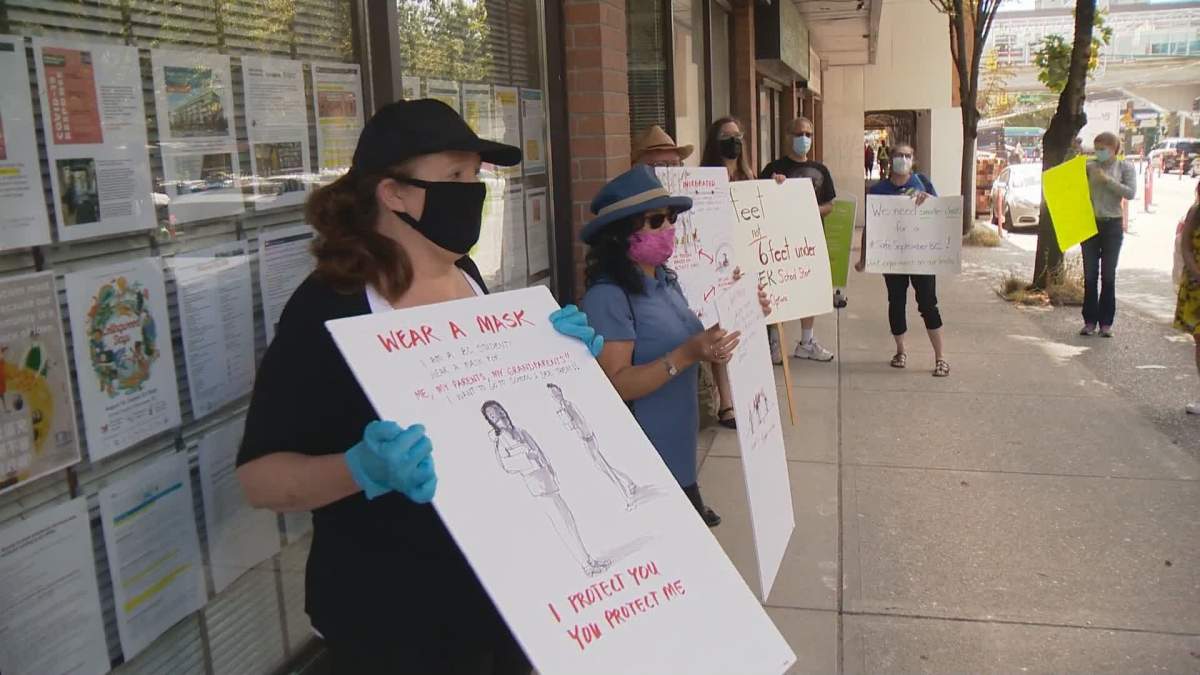 Former Vancouver school board trustee Carrie Bercic pickets with parents and teachers outside of Health Minister Adrian Dix's office.