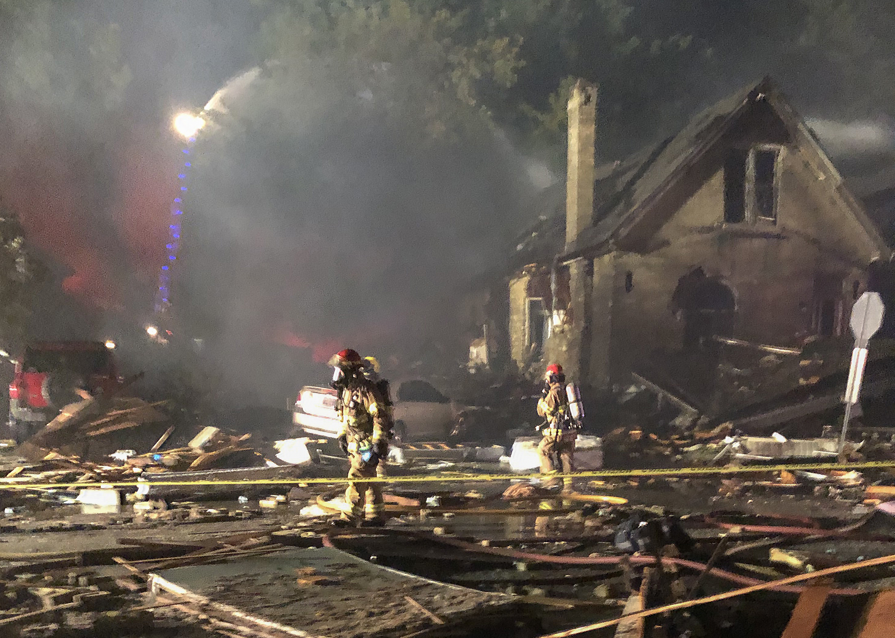 Fire crews work at the scene of 450 Woodman Ave. the night of the explosion.