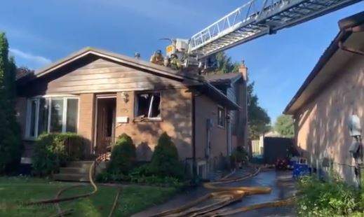 Fire crews can be seen on the roof battling a blaze that broke out at a Gatewood Rd residence. 