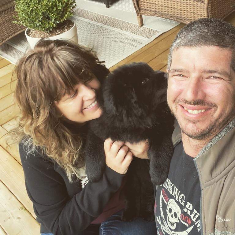 Stewart, B.C. Mayor Gina McKay poses for a photo with her partner Chris Fellers and their puppy Harper in this undated handout photo. The town of Stewart, B.C., is doing what it can to help neighbours in the smaller, more isolated Hyder, Alaska. Stewart Mayor Gina McKay said residents of Hyder don't even have a gas station, and are allowed to cross into Stewart once a week for essentials like groceries.