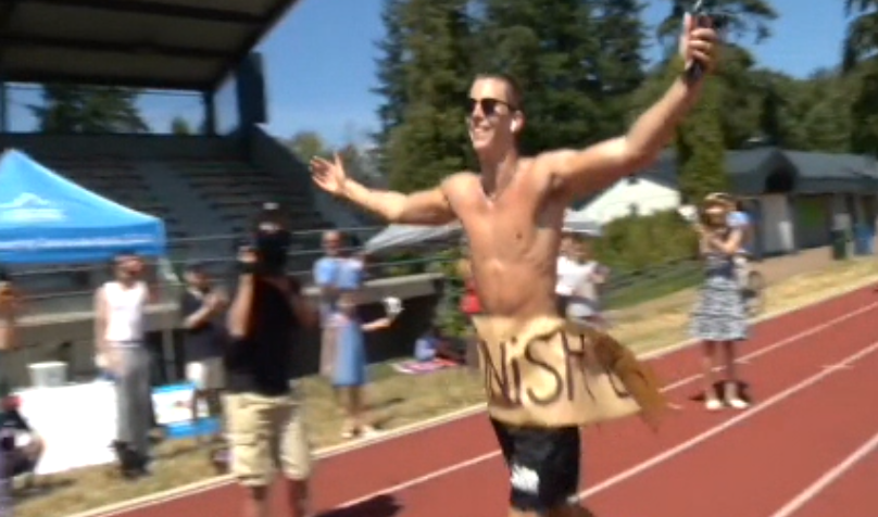 Owen Ostler crosses the finish line after completing a solo marathon for Lions Gate Hospital on Saturday. 