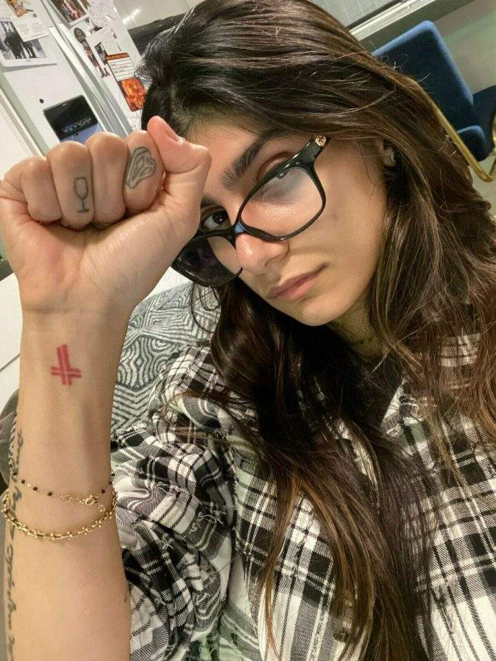 Mia Khalifa showcases her glasses for an eBay auction.