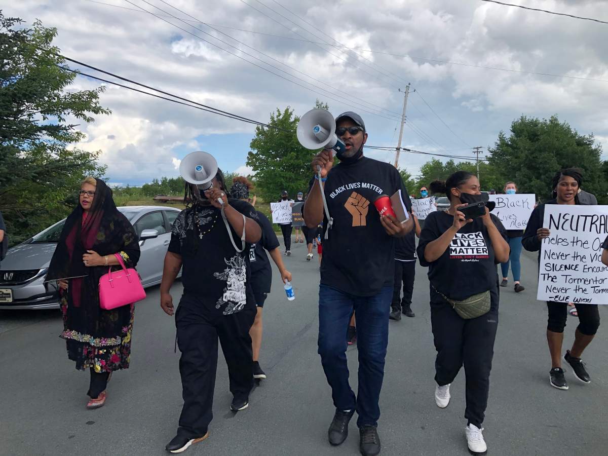 Community organizers Steven Benton (centre) and Marcus Owen (left) lead a Black Lives Matter march through North Preston, N.S. on Aug. 1, 2020.