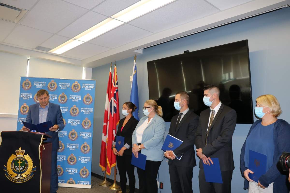 Peterborough-Kawartha MPP Dave Smith congratulates members of the Peterborough Police Service special victims unit during a funding announcement Tuesday at the police station. 