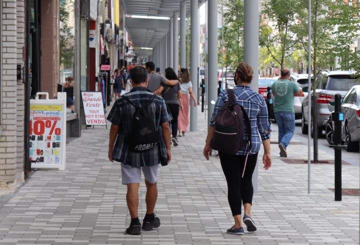 Pedestrians walk alongside the north section of Plaza Saint-Hubert, between Saint-Zotique to Jean Talon Street, where roadwork is complete and sidewalks are renovated on Tuesday, Aug. 11, 2020.