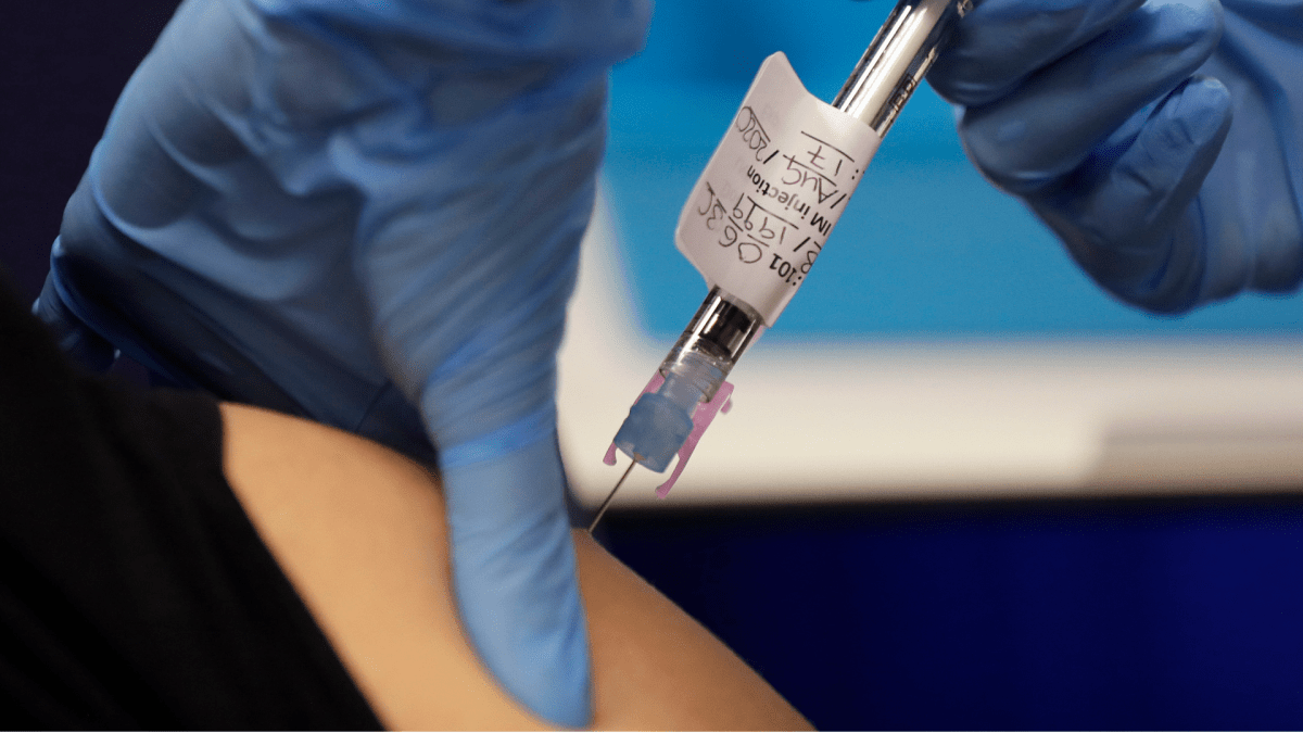 A volunteer is injected with a trial vaccine as part of a vaccine trial at a clinic in London, England.