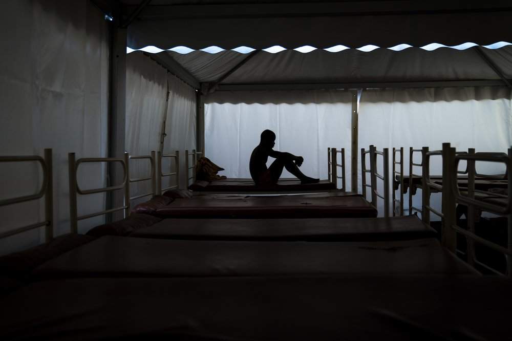 Mamadou Patherazi, from Guinea, sits on a bunk bed of the Modern Christian Mission Church in Fuerteventura, one of the Canary Islands, Spain, on Saturday, Aug. 22, 2020. The Modern Christian Mission is the main shelter for rescued migrants on the island of Fuerteventura. Some 4,000 migrants have reached the Canaries so far this year, the most in over a decade, raising alarm at the highest levels of the Spanish government.