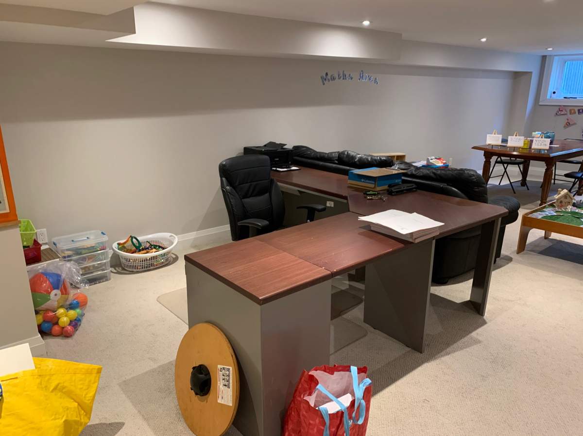 The learning pod set up in Kathryn Child’s basement. A desk for the teacher and students.