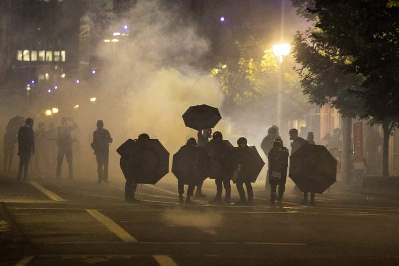 Tear gas fills the air during protests, Friday, Sept. 18, 2020, in Portland, Ore.