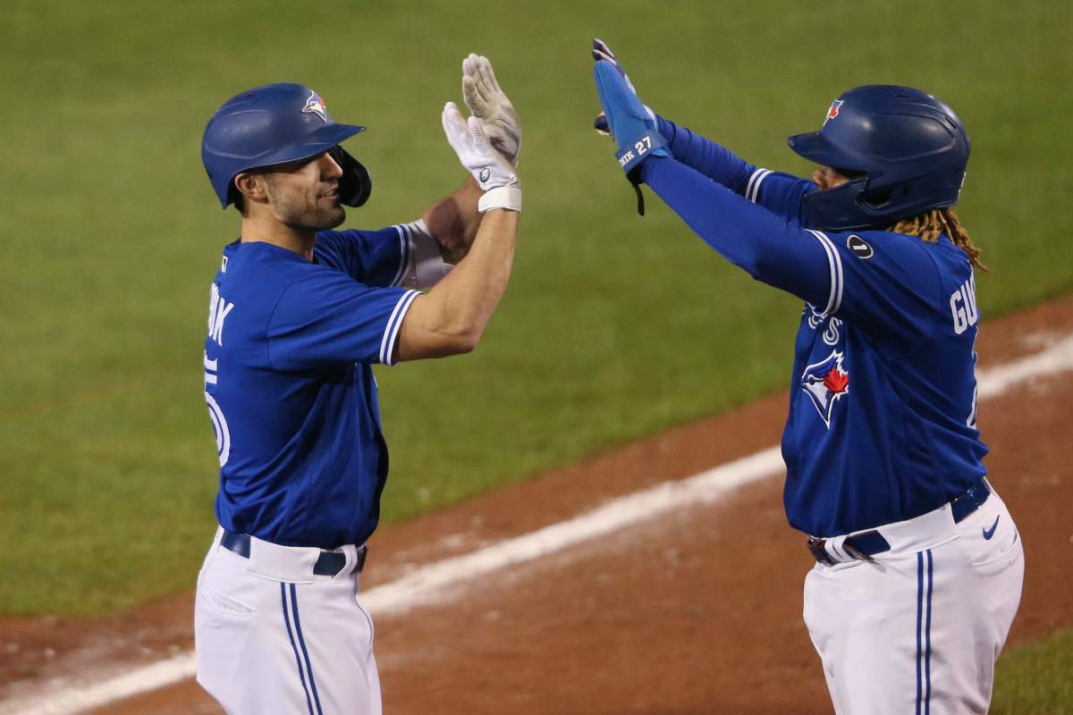 Toronto Blue Jays Randal Grichuk, left, celebrates his three-run home run with Vladimir Guerrero Jr. during the seventh inning of the team's baseball game against the Baltimore Orioles, Saturday, Sept. 26, 2020, in Buffalo, N.Y.