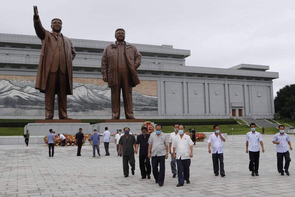 People visit the statues of former North Korean leaders Kim Il Sung, left, and Kim Jong Il, right, to lay flowers on the occasion of the 67th anniversary of the end of the Korean War, which the country celebrates as the day of "victory in the fatherland liberation war" in Pyongyang, Monday, July 27, 2020. 