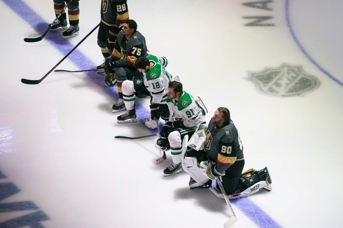 FILE - In this Aug. 3, 2020, file photo, Dallas Stars' Jason Dickinson (18), Tyler Seguin (91) and Vegas Golden Knights' Ryan Reaves (75) and goalie Robin Lehner (90) take a knee for Black Lives Matter during the national anthem prior to an NHL hockey playoff game in Edmonton, Alberta.