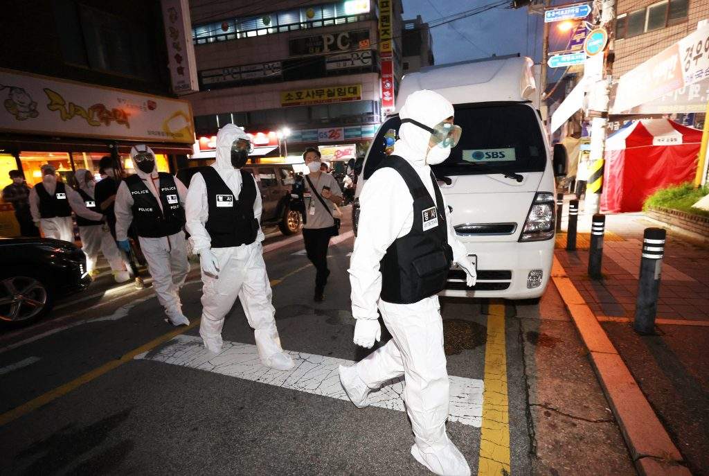 Police officers head towards Sarang Jeil Church for a search and seizure operation, in Seoul, South Korea, 21 August 2020. A court issued a warrant after health authorities failed to secure the full list of the members of the church at the center of recent spikes in coronavirus infections in the country.  
