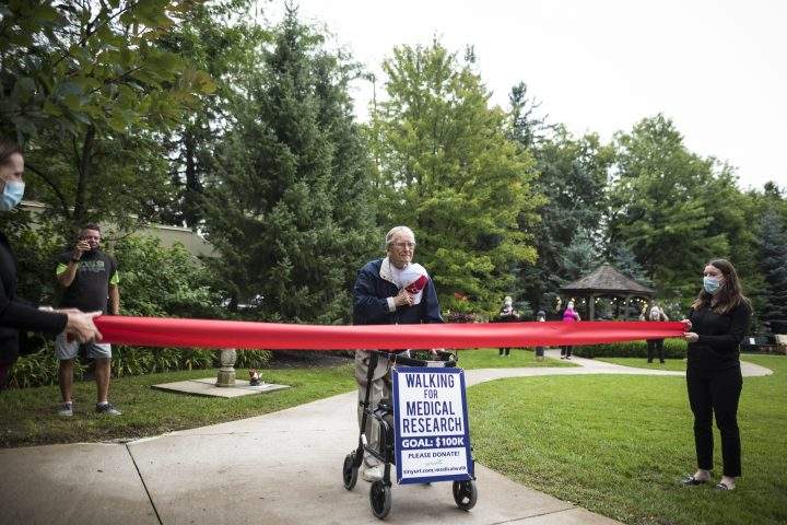 George Markow, a 99-year-old Second World War Veteran, reaches the finish line after completing his 100 km walking milestone, in a special fundraising effort to raise $100,000 for COVID-19 medical research, at the Roxborough Retirement Residence in Newmarket, Ont., on Wednesday, September 2, 2020.
