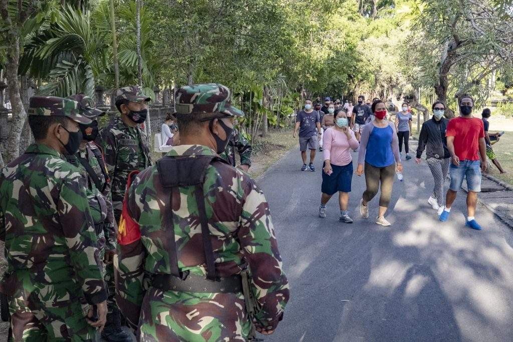 Military officer patrol during a mask wearing and public health protocols campaign at a check point in Denpasar, Bali, Indonesia, 07 September 2020. Local authorities in Bali hand out a fine of one hundred thosand Rupiah (around 7 US dollars) for people who disregard the wearing of a face mask in public.  