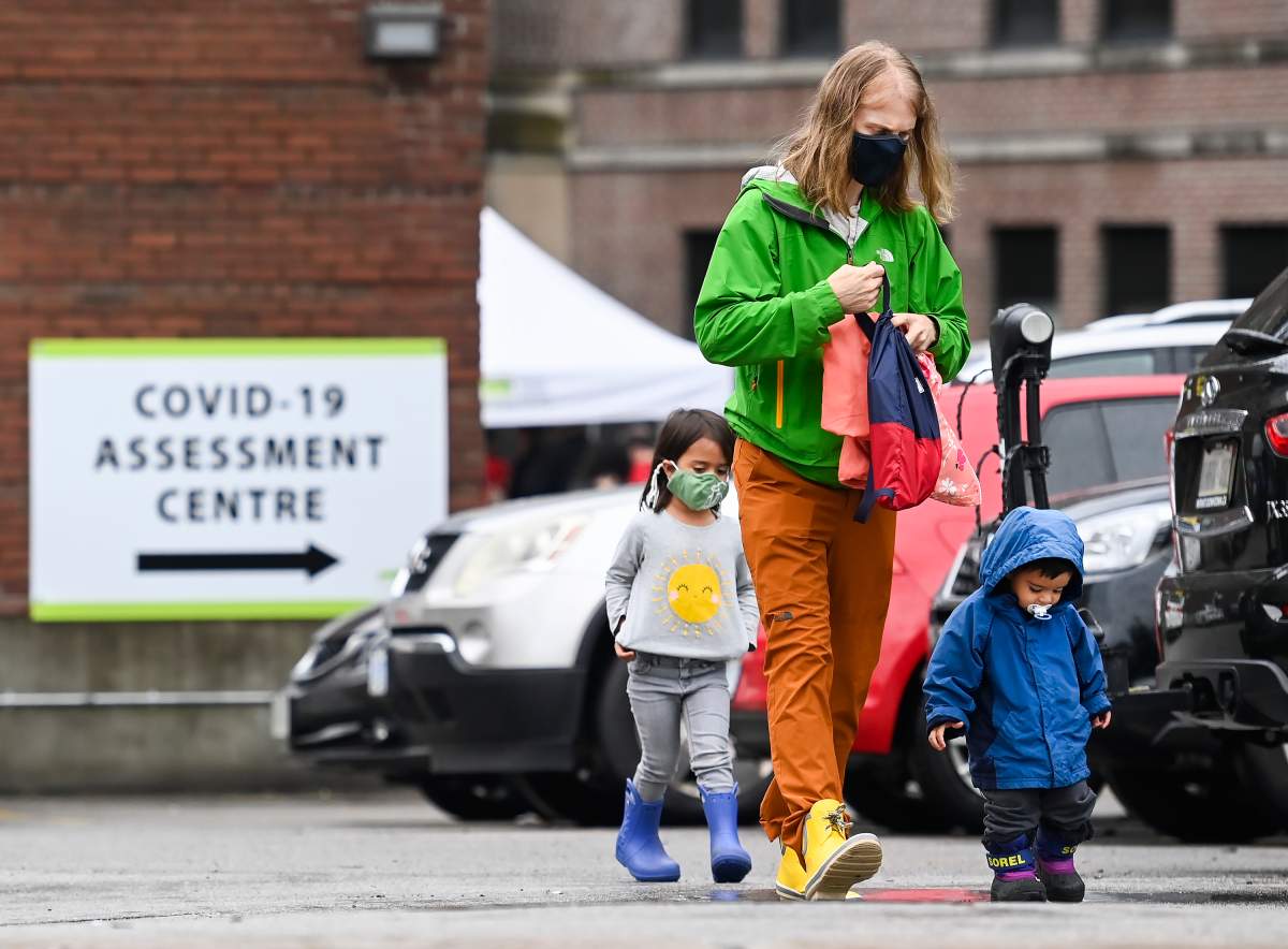 A family walks to line up to be tested for COVID-19 at a testing centre in Toronto on Sunday, Sept. 13, 2020. 