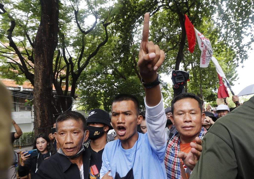 Pro-democracy protester Panupong Jadnok gestures as he enters the gate to Thammasat University during a protest in Bangkok, Thailand, Saturday, Sept. 19, 2020. Protesters gathered Saturday in Bangkok for what was expected to be the biggest rally yet in an ongoing campaign calling for a new election and democratic reforms. 