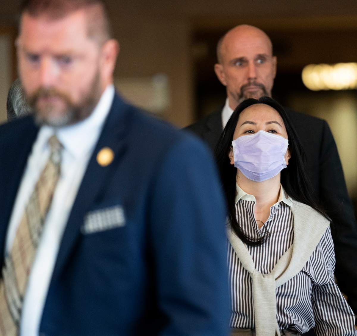 Meng Wanzhou is surrounded by security as she leaves B.C. Supreme Court in Vancouver, Monday, September 28, 2020.  