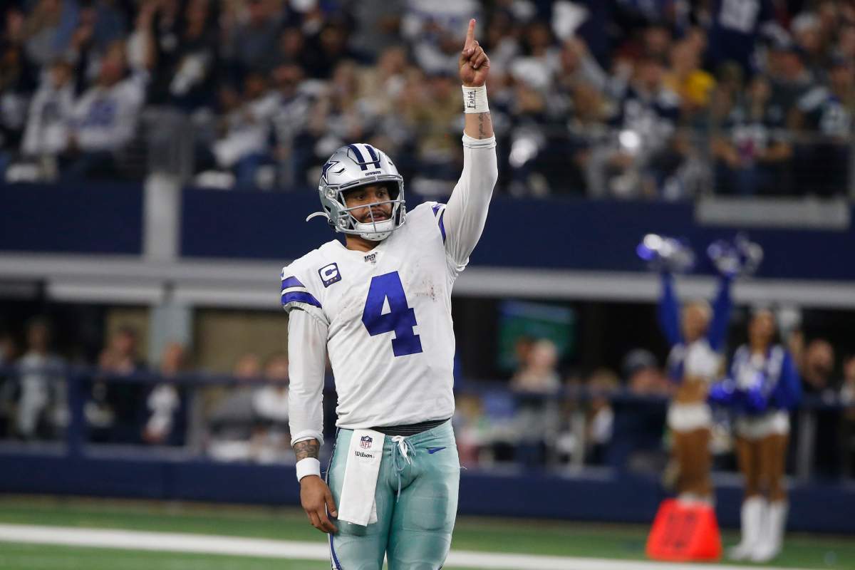 FILE-Dallas Cowboys quarterback Dak Prescott (4) celebrates a touchdown against Washington in Arlington, Texas, Sunday, Dec. 15, 2019.