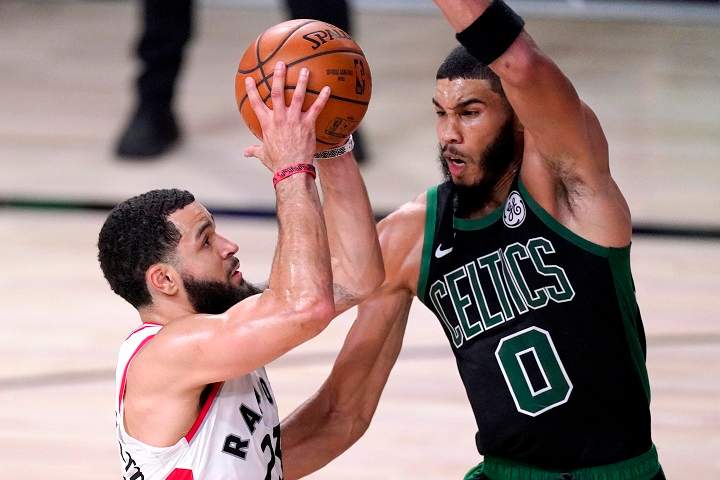 Toronto Raptors' Fred VanVleet, left, goes up for a shot against Boston Celtics' Jayson Tatum during the first half of an NBA conference semifinal playoff basketball game Friday, Sept. 11, 2020, in Lake Buena Vista, Fla. (AP Photo/Mark J. Terrill).