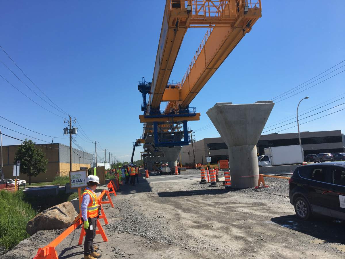 Workers assembling the new REM light rail network for greater Montreal