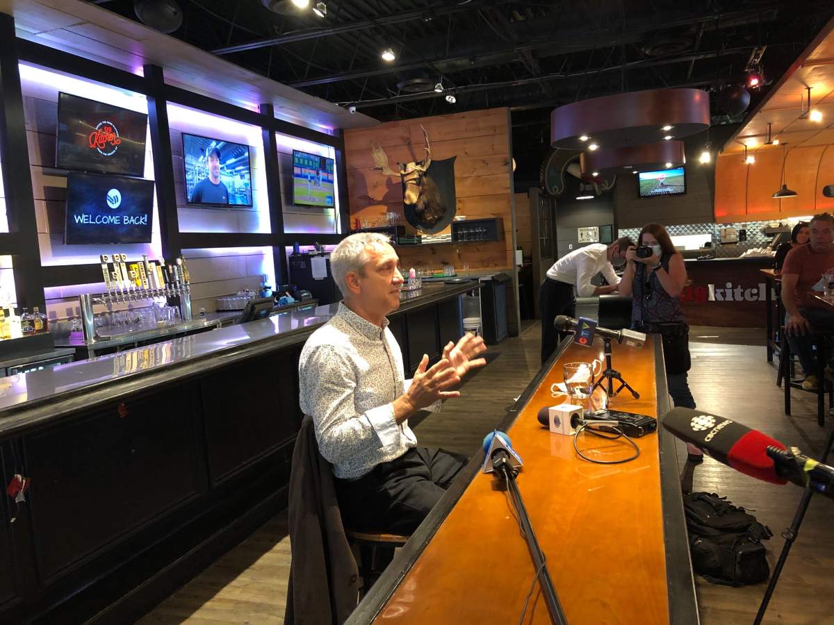 Jerry Pribil of Marienbad Restaurant addresses fellow local business owners during a news conference inside Toboggan Brewing Co. on Wednesday.