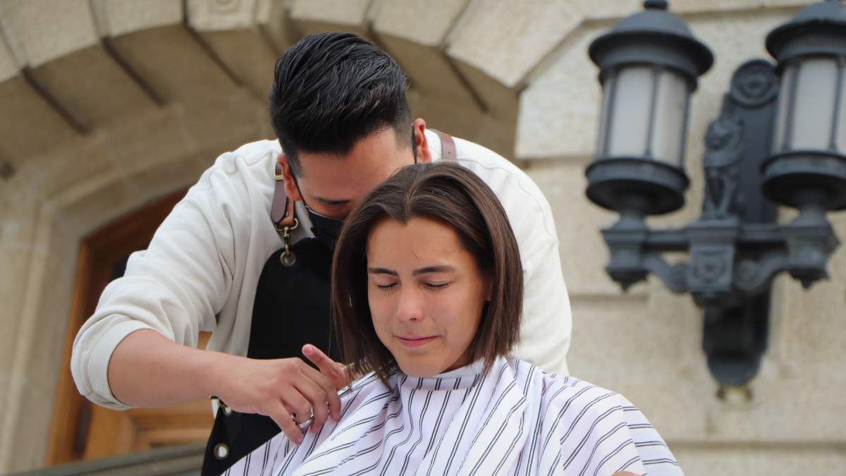 Tristen Durocher voluntarily has his braid cut off on the front steps of the Saskatchewan legislative building on Sept. 13, 2020