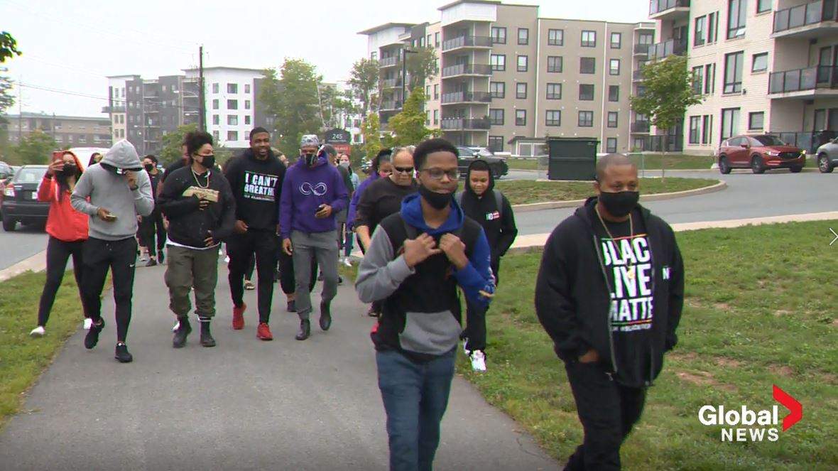 Dozens gathered outside Charles P. Allen High School to walk 16-year-old Demario Chambers to school on Tuesday, Sept. 8, 2020.
