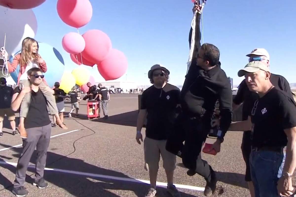 Illusionist David Blaine can be seen hanging from a balloon apparatus while speaking to his daughter Dessa, left, in Arizona on Sept. 2, 2020.
