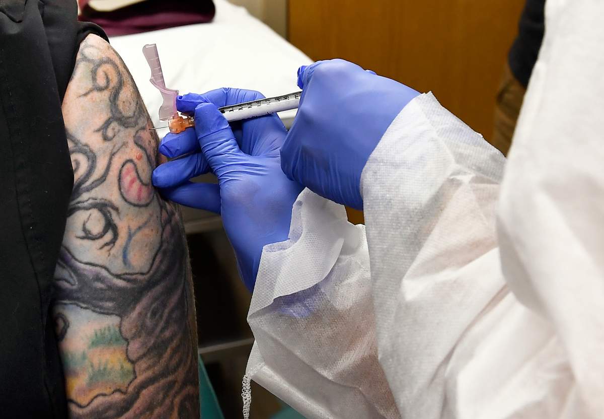 A volunteer in New York receives an injection in a world study of a possible COVID-19 vaccine.
