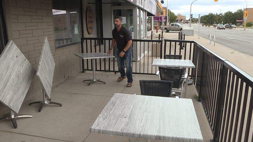 Tony Siwicki, the owner of Silver Heights Restaurant, setting up tables on the patio on Labour Day.