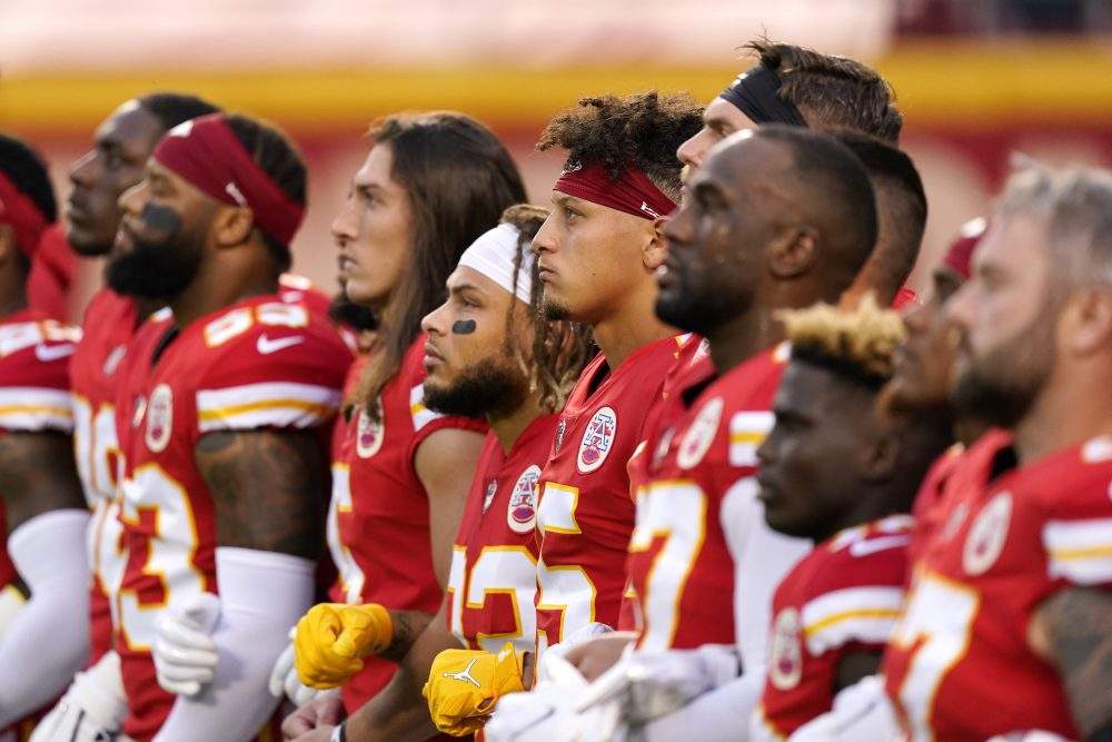 Kansas City Chiefs players, including quarterback Patrick Mahomes (15), stand for a presentation on social justice before an NFL football game against the Houston Texans Thursday, Sept. 10, 2020, in Kansas City, Mo.
