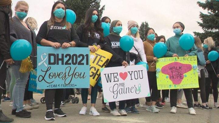 University of Alberta dental hygiene students hold signs in support of their professor who was diagnosed with ovarian cancer.