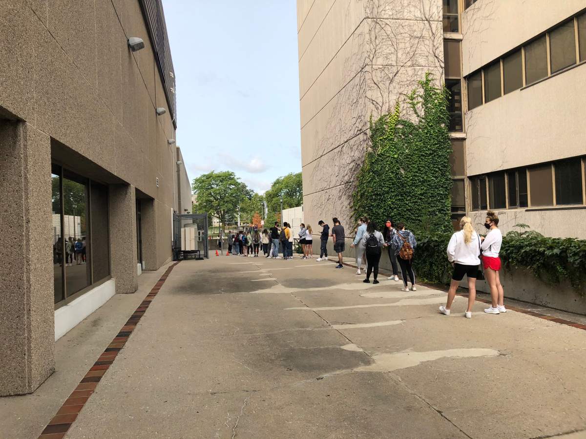 Western University students line up for an on-campus COVID-19 testing centre on Monday morning.