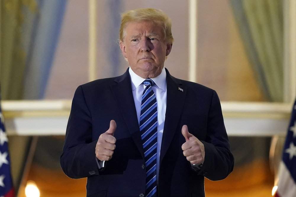 President Donald Trump stands on the balcony outside of the Blue Room as returns to the White House Monday, Oct. 5, 2020, in Washington, after leaving Walter Reed National Military Medical Center, in Bethesda, Md. Trump announced he tested positive for COVID-19 on Oct. 2. 