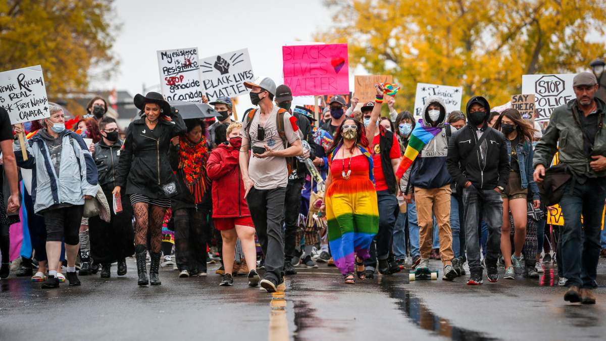 Demonstrators march during an anti-racism event in Red Deer, Alta., Sunday, Oct. 4, 2020.