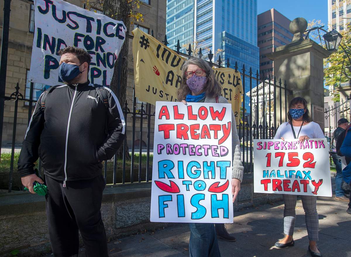 Supporters stand in line as Cheryl Maloney, a member of the Sipekne’katik First Nation, and activist, sells lobster outside the legislature in Halifax on Oct. 16, 2020.