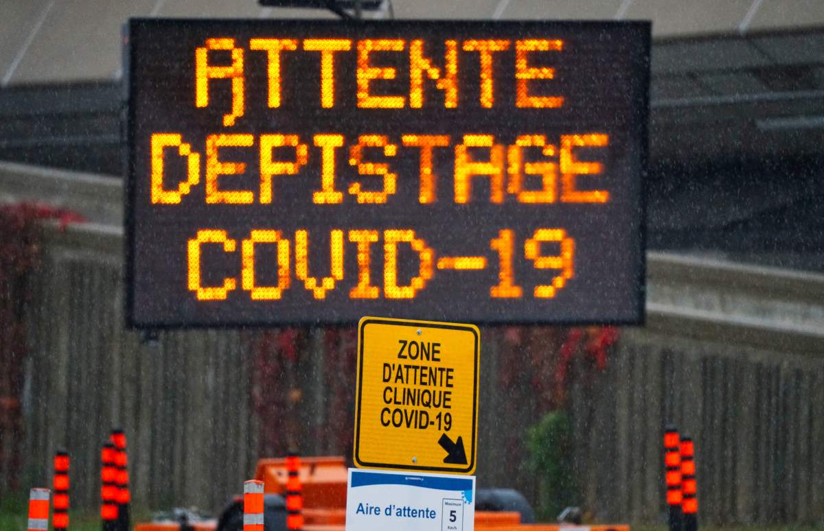 Sign indicating waiting line for the drive-thru testing of COVID-19 in Montreal, Que., Wednesday, October 21, 2020. 
