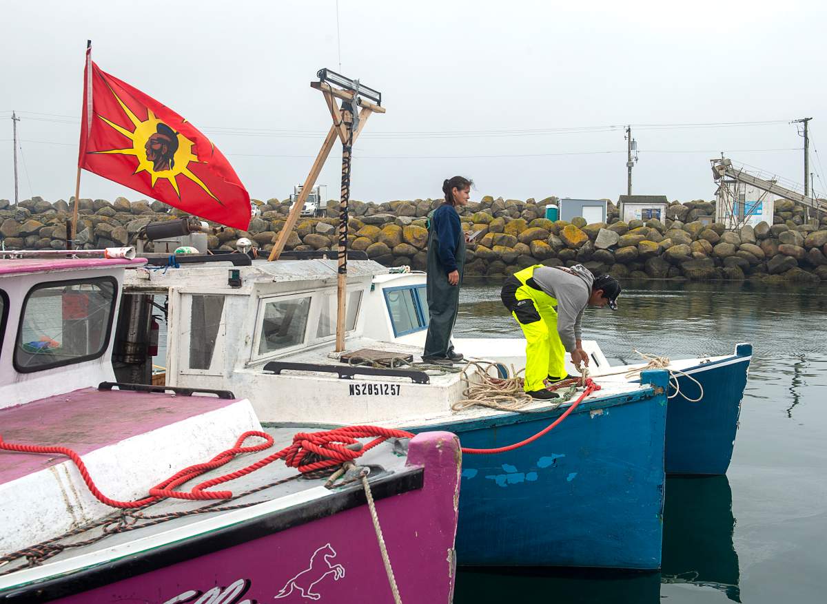 Indigenous fishermen adjust lines on their boat in Saulnierville, N.S. on Wednesday, Oct. 21, 2020. Tensions remain high over an Indigenous-led lobster fishery that has been the source of conflict with non-Indigenous fishermen. THE CANADIAN PRESS /Andrew Vaughan