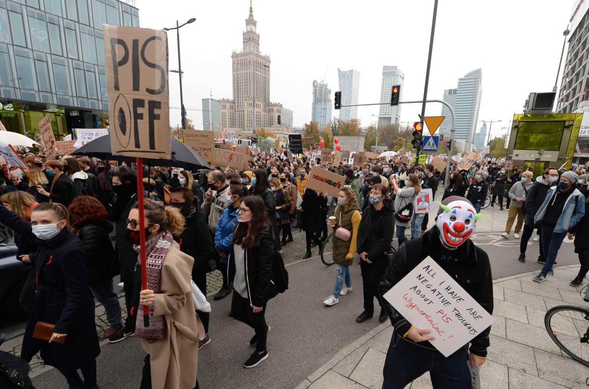 Women’s rights activists with posters of the Women’s Strike action protest in Warsaw, Poland, Wednesday, Oct. 28, 2020 against recent tightening of Poland’s restrictive abortion law.